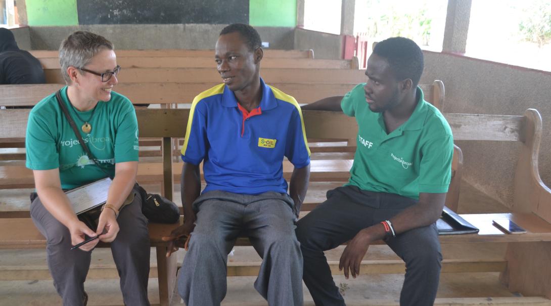 Projects Abroad volunteer doing a social work project shares ideas with local staff in Ghana.