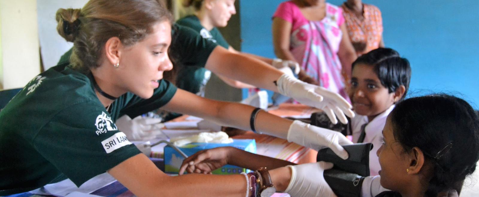 Students on a medical school gap year program work at an outreach in Sri Lanka.