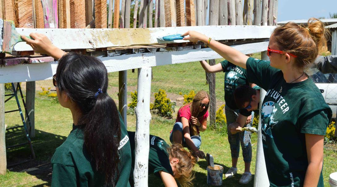 Teenage care volunteers take part in renovation work in a care center in Kenya during their internship with Projects Abroad.