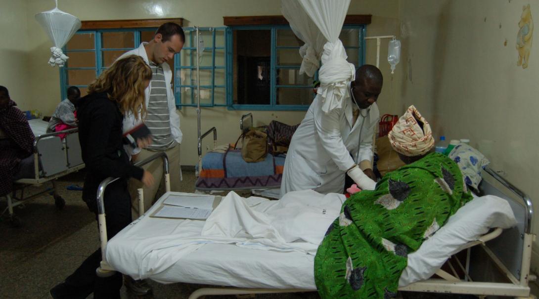 A couple of Projects Abroad volunteers observe the work of a local doctor in the maternity ward of a hospital in Ghana during their midwifery internship.