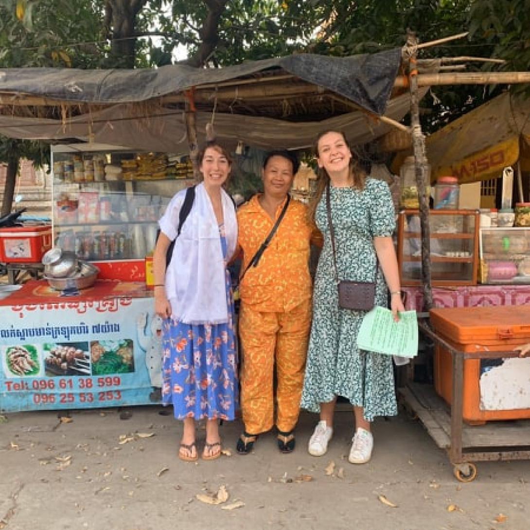 Food seller beneficiary with volunteers from Projects Abroad micro-finance internship