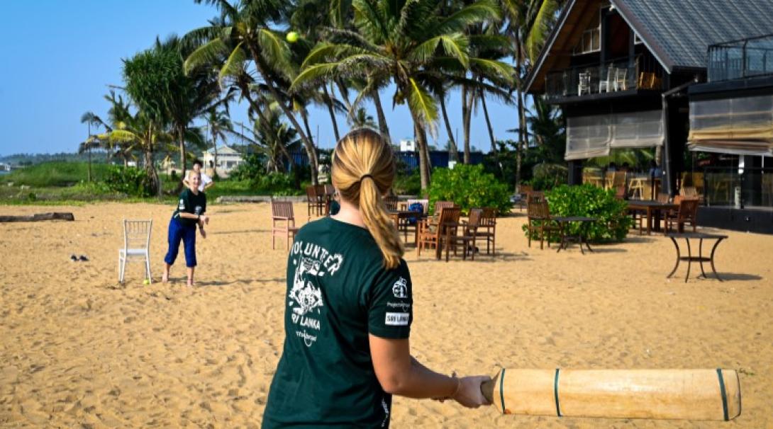 Volunteers playing cricket on the beach