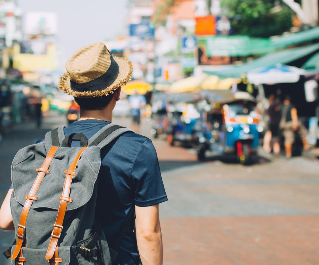 A volunteer abroad goes to a local market to practice his new vocabulary.