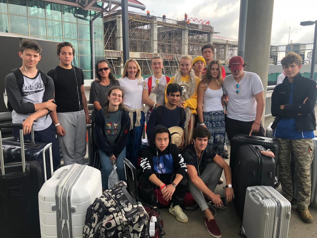 Volunteers from Switzerland wait for their transportation after arriving at the airport