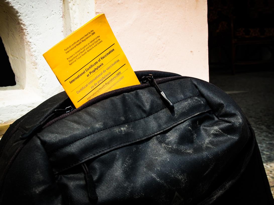 Certificate for the yellow fever vaccination being packed into backpack